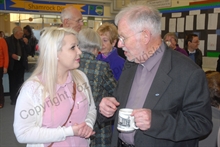 Father Harrington in the School Canteen with a parishioner